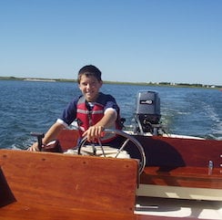 Stuart as a child on his boat