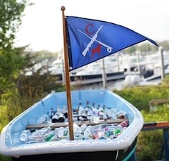 retired boat on grass filled with beers